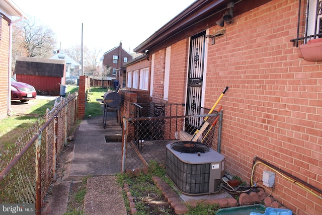 view of property exterior with an outdoor structure and central AC unit