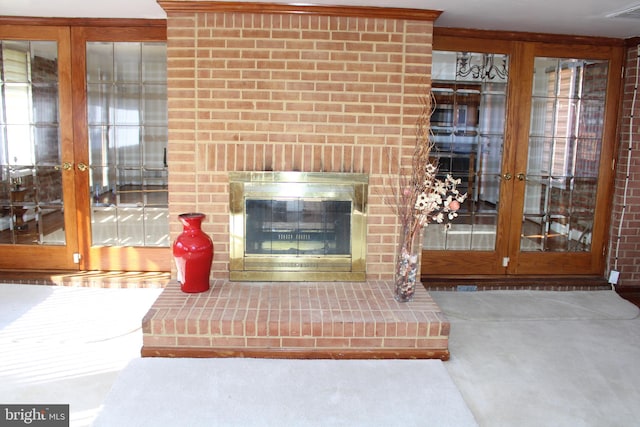 unfurnished living room with a fireplace, carpet, and french doors