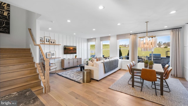 dining space featuring light hardwood / wood-style flooring and a chandelier