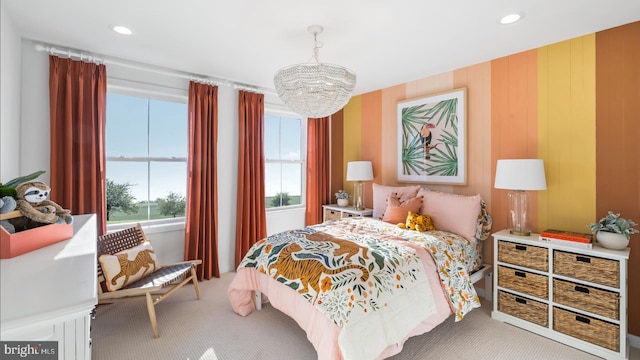 bedroom featuring light carpet and a chandelier