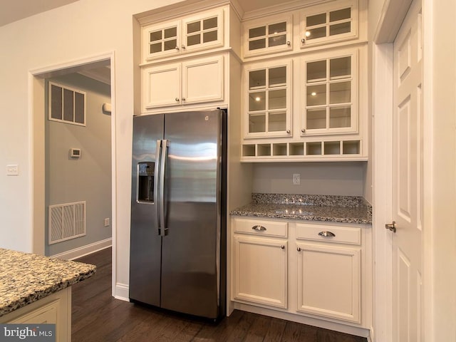 kitchen featuring white cabinets, dark wood-type flooring, light stone countertops, and stainless steel fridge with ice dispenser