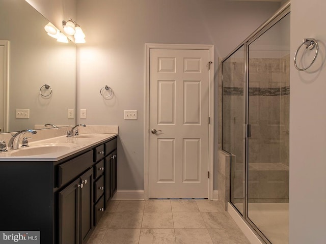 bathroom with an enclosed shower, tile floors, and double sink vanity