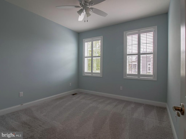 empty room featuring light carpet and ceiling fan