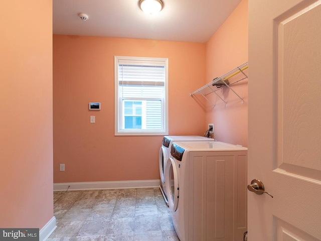 clothes washing area with separate washer and dryer and light tile floors