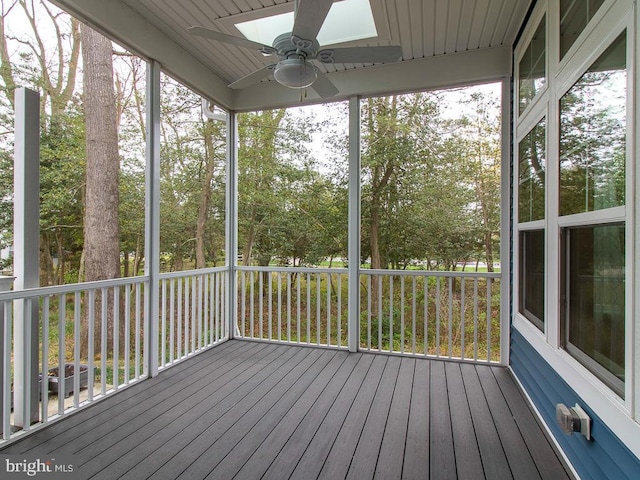 unfurnished sunroom featuring a skylight and ceiling fan