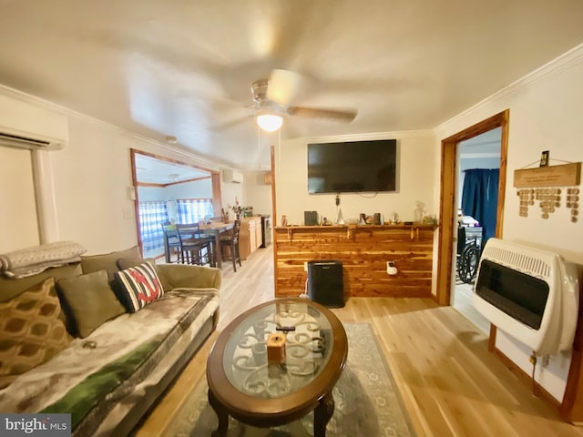 living room with ceiling fan, ornamental molding, a wall unit AC, and light hardwood / wood-style floors