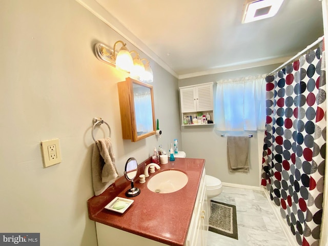 bathroom with tile floors, ornamental molding, vanity, and toilet