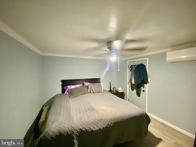 bedroom featuring ceiling fan, an AC wall unit, ornamental molding, a closet, and light wood-type flooring