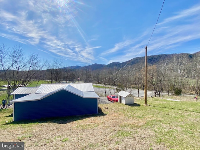 exterior space featuring a mountain view and a shed