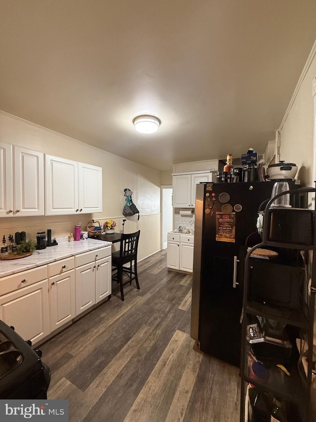 1705 S Clinton Ave, Trenton, NJ 08610 - kitchen with white cabinets, light countertops, freestanding refrigerator, and dark wood-style flooring