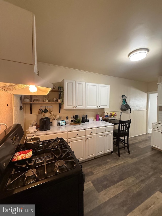 1705 S Clinton Ave, Trenton, NJ 08610 - kitchen with white cabinets, a wainscoted wall, light countertops, open shelves, and gas range oven