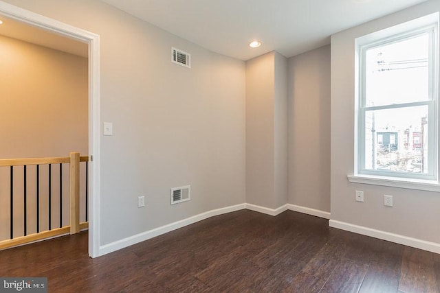 empty room with dark hardwood / wood-style floors