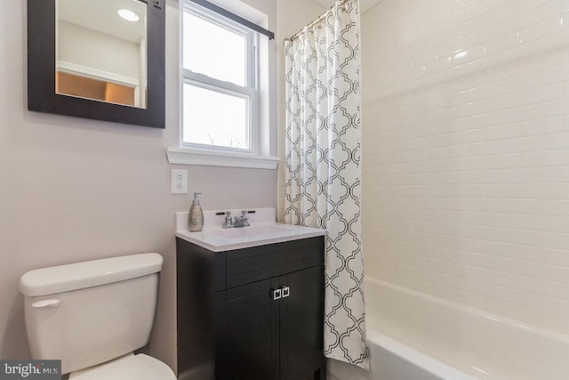 full bathroom featuring shower / bath combo, oversized vanity, and toilet