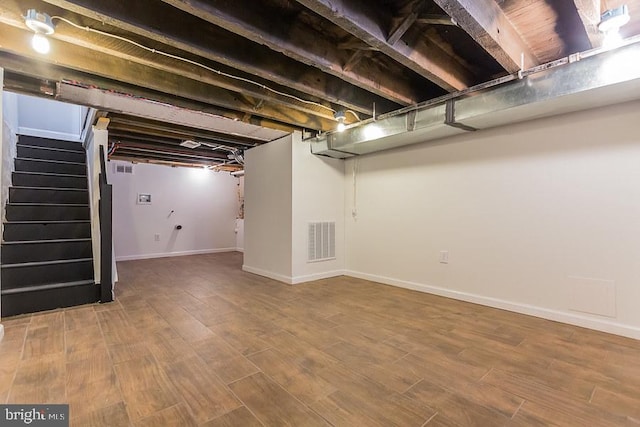 basement featuring wood-type flooring