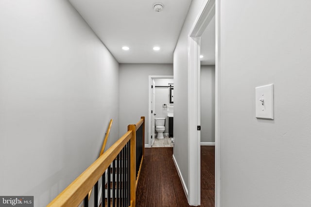 hallway with dark hardwood / wood-style floors