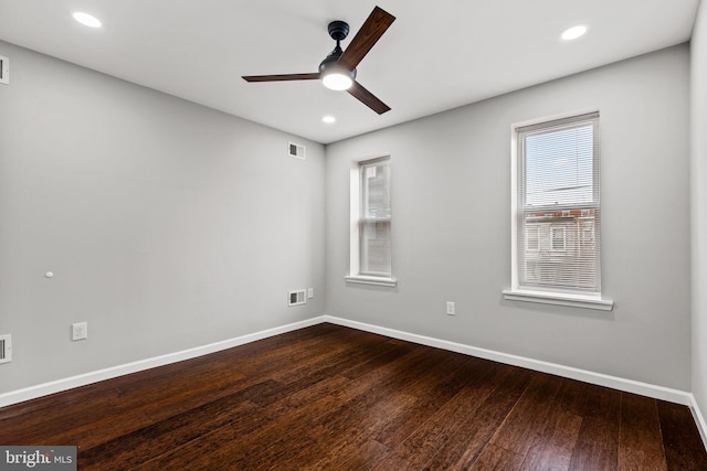 unfurnished room featuring ceiling fan and dark wood-type flooring