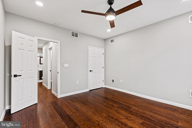 spare room featuring ceiling fan and dark wood-type flooring