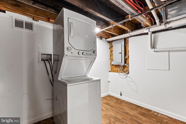 washroom with hookup for a washing machine, light wood-type flooring, and stacked washer and clothes dryer