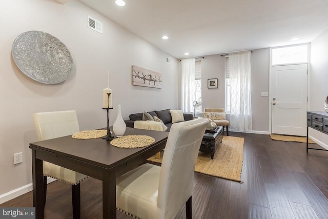 dining space featuring dark wood-type flooring