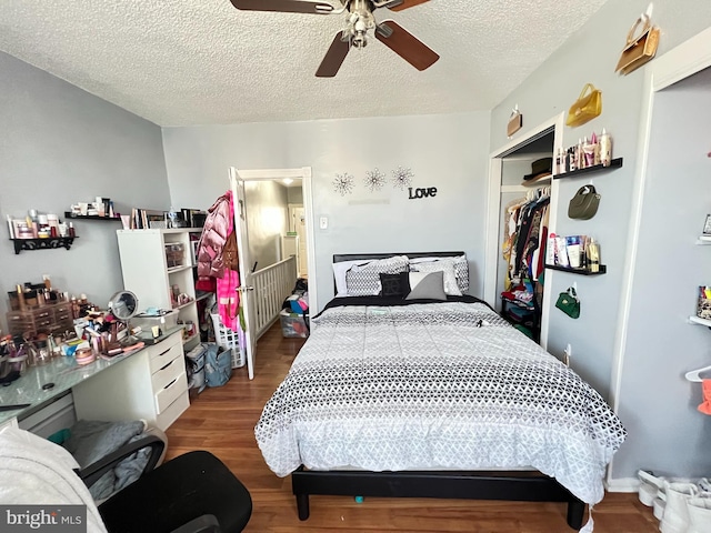 bedroom with a closet, hardwood / wood-style floors, a textured ceiling, and ceiling fan