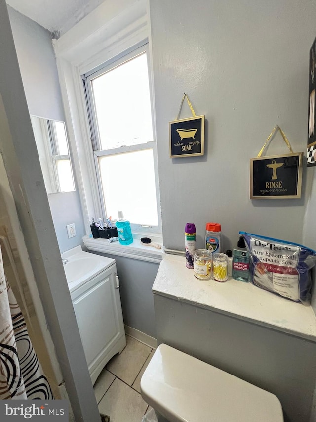 bathroom featuring tile floors and vanity