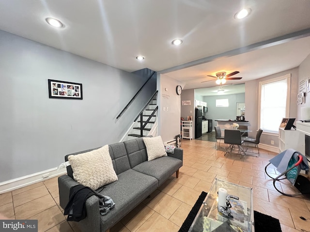 tiled living room featuring ceiling fan