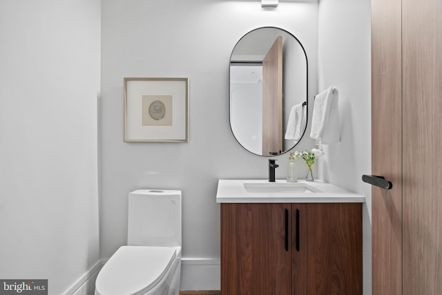 bathroom featuring toilet and vanity