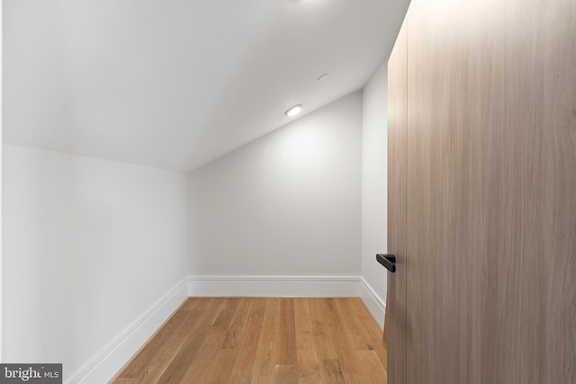 bonus room featuring lofted ceiling and light hardwood / wood-style flooring