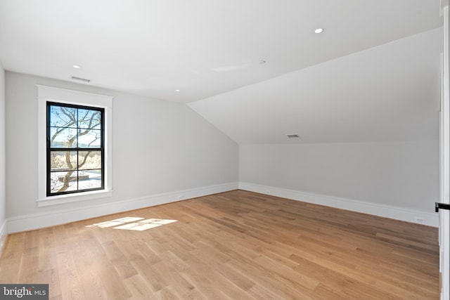 bonus room with light hardwood / wood-style flooring and lofted ceiling