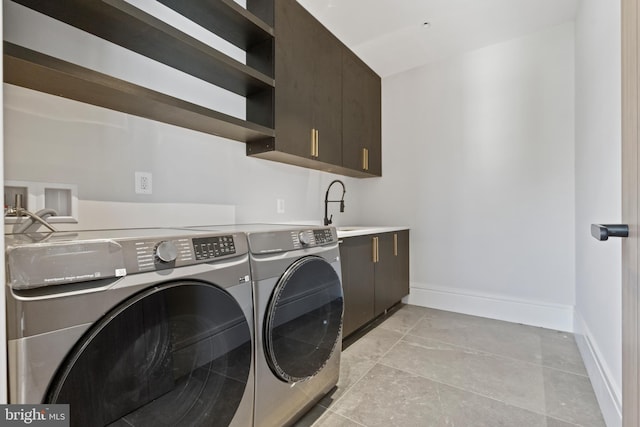 laundry area featuring light tile flooring, cabinets, hookup for a washing machine, washing machine and dryer, and sink