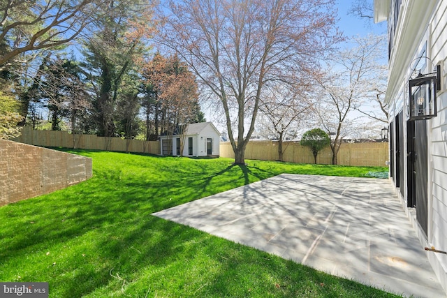 view of yard featuring an outdoor structure and a patio