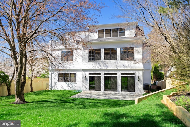 rear view of property featuring a patio and a yard