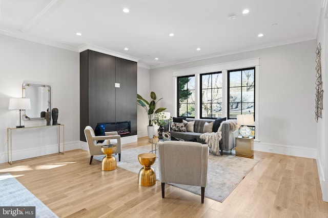 living room featuring light hardwood / wood-style flooring and ornamental molding