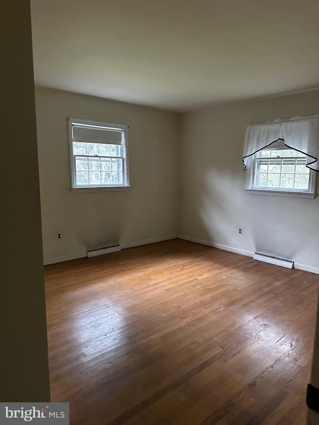 spare room featuring light hardwood / wood-style floors and baseboard heating