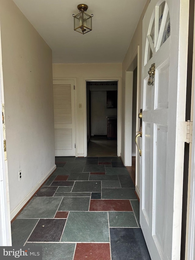 corridor with dark tile floors