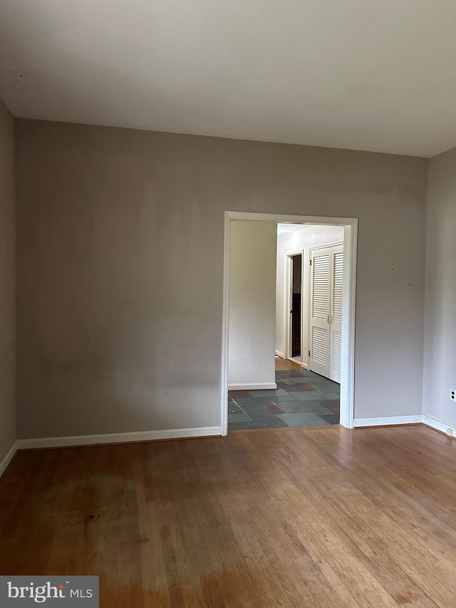 spare room with dark hardwood / wood-style flooring