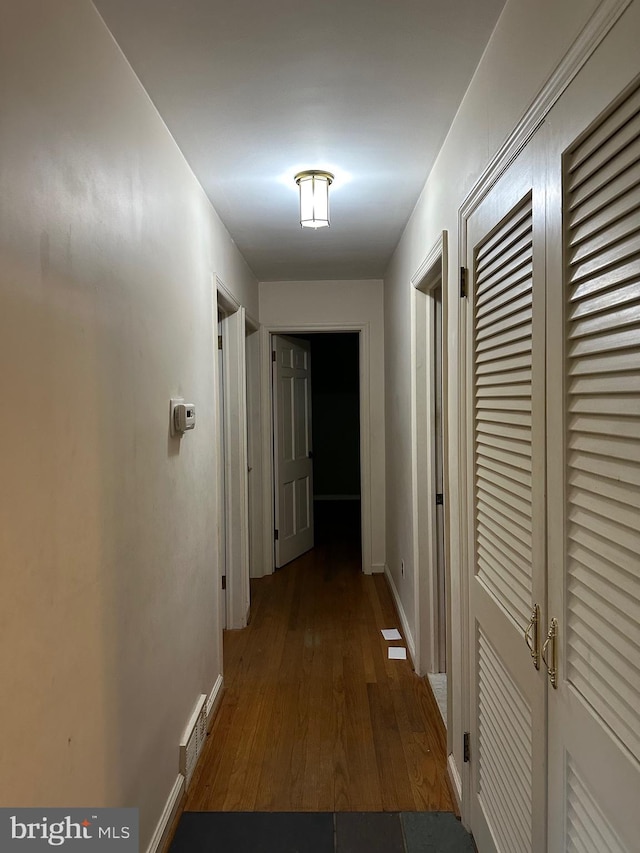 hallway featuring dark wood-type flooring