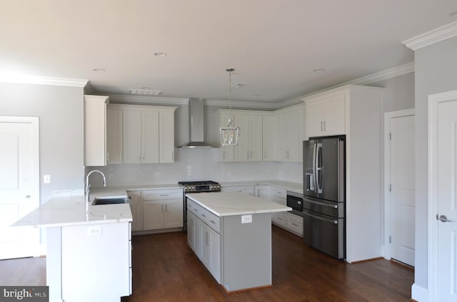 kitchen with a center island, wall chimney exhaust hood, sink, and stainless steel appliances