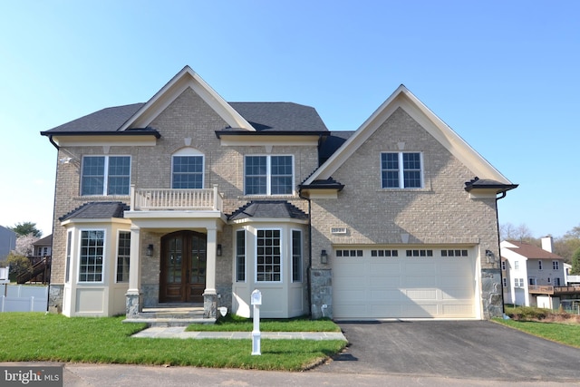 view of front of house featuring a front lawn and a garage