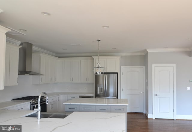 kitchen with wall chimney range hood, light stone counters, stainless steel appliances, dark hardwood / wood-style flooring, and white cabinetry