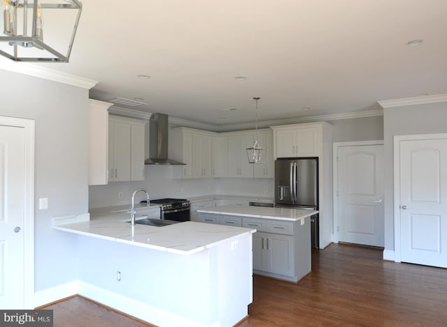 kitchen with wall chimney exhaust hood, hanging light fixtures, dark hardwood / wood-style flooring, and white cabinets