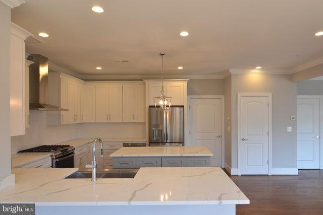 kitchen featuring light stone countertops, dark hardwood / wood-style floors, a notable chandelier, appliances with stainless steel finishes, and wall chimney range hood