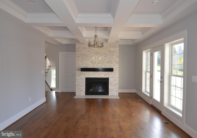 unfurnished living room with coffered ceiling, a fireplace, dark wood-type flooring, and a healthy amount of sunlight