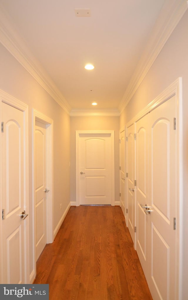 hall featuring dark hardwood / wood-style flooring and ornamental molding