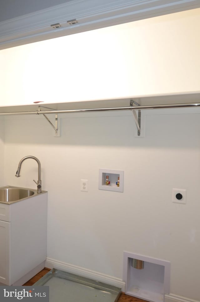 clothes washing area with dark wood-type flooring, electric dryer hookup, sink, and hookup for a washing machine