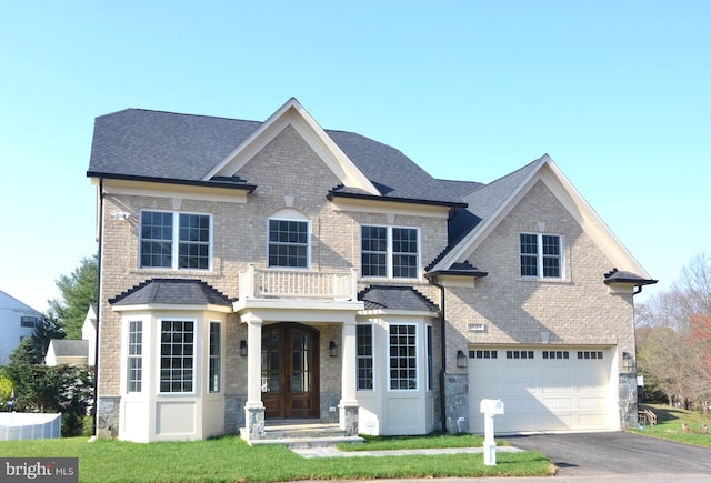 view of front of house with a front yard and a garage