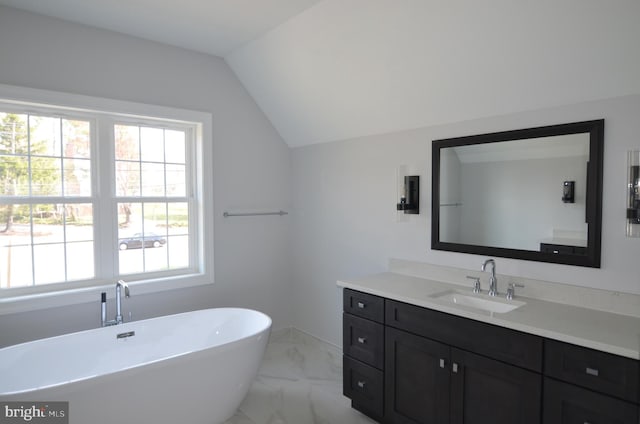 bathroom with lofted ceiling, tile flooring, vanity, and a wealth of natural light