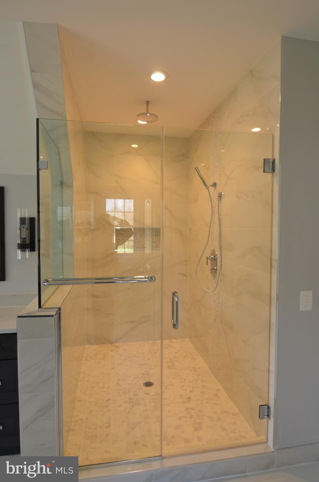 bathroom with a shower with shower door