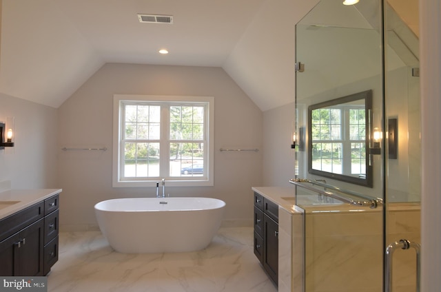 bathroom with a washtub, tile flooring, vanity, and vaulted ceiling