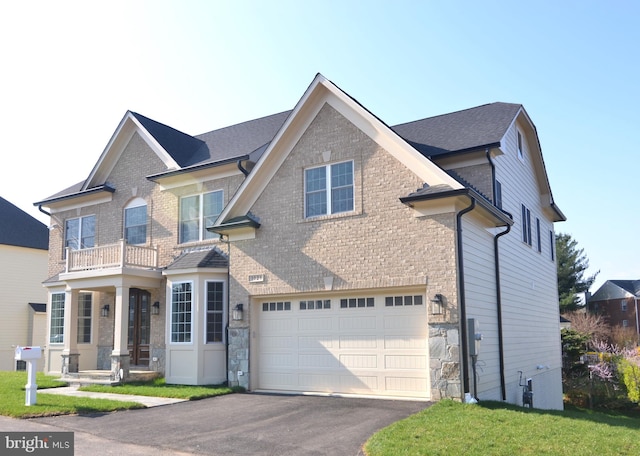 view of front facade featuring a balcony and a garage